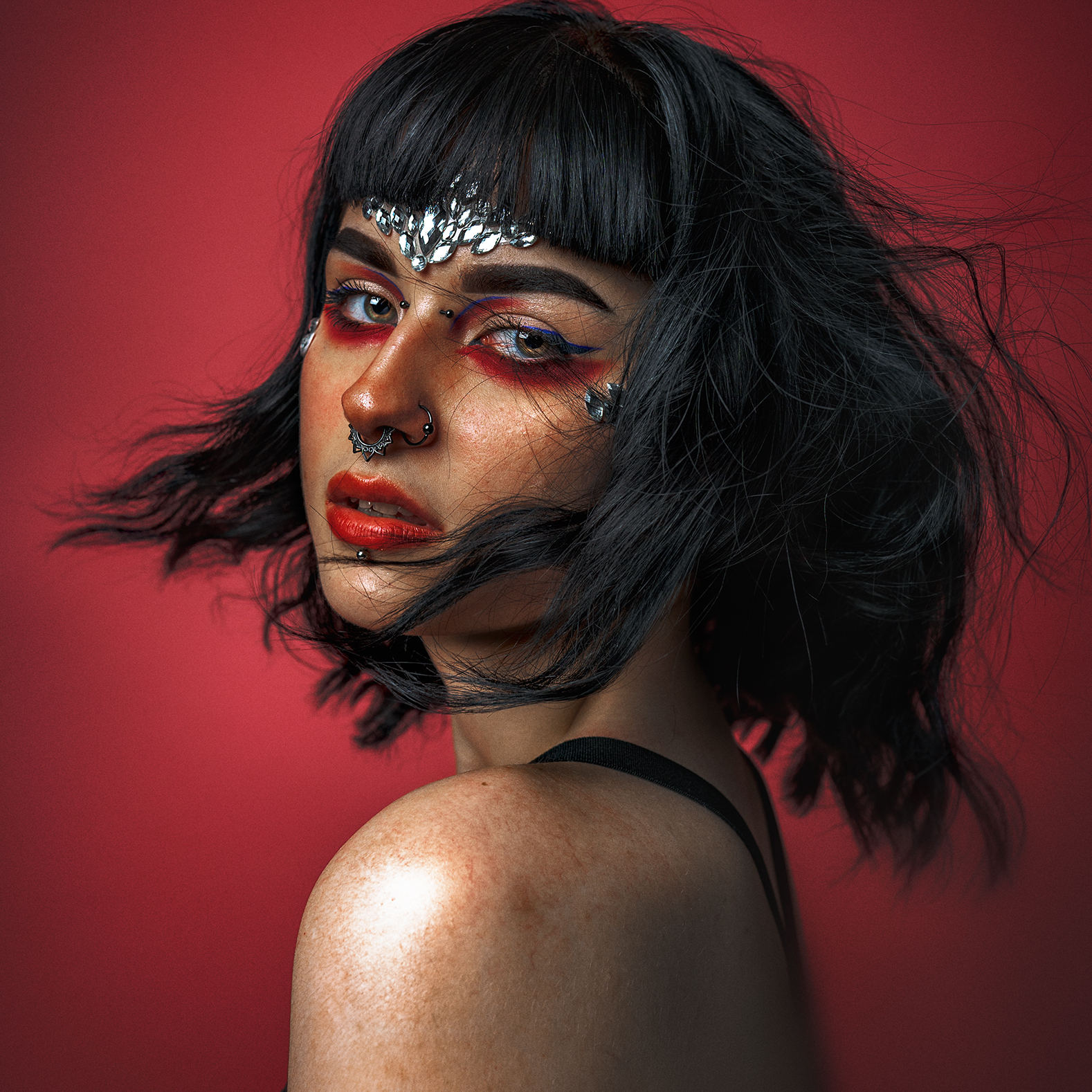 woman wearing face paint looking over her left shoulder