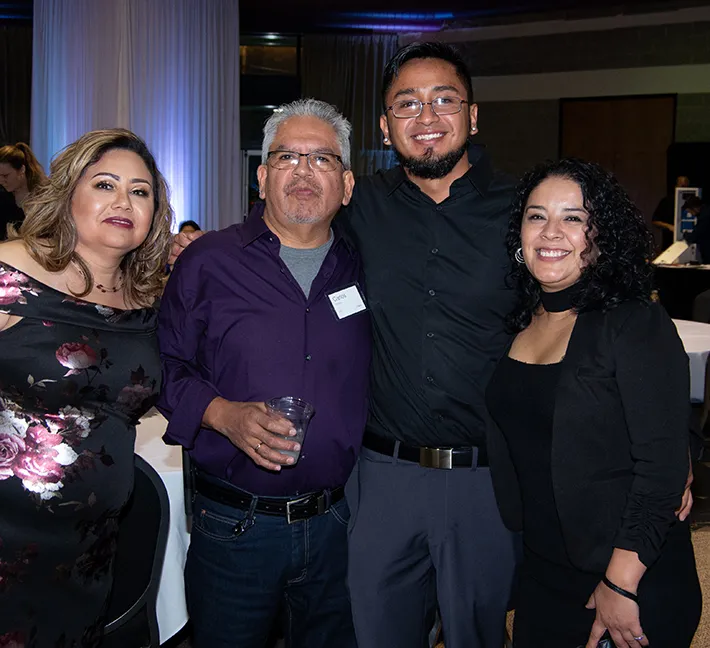 2 couples smiling and posing for camera